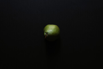 Top view of a green pear isolated on a black background