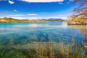 Panoramic view of Lake Banyoles with one of the old boathouses, recently restored as a bar terrace. Banyoles, Catalonia, Spain