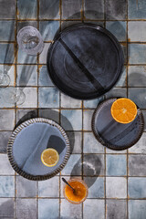 Sunny lunch, siesta table setting on blue and grey ceramic tile background table with long shadows