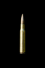 Rifle bullet long cartridge on black background.
