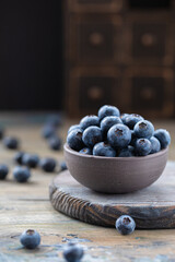 Fresh blueberries in a bowl on a wooden table