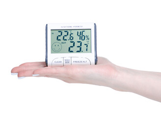 electronic clock thermometer hygrometer in hand on white background isolation
