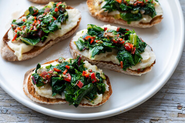 Crostini with white bean puree and Swiss chard