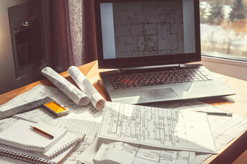 Architect works remotely from home in quarantine, lockdown covid 19 coronavirus. Remote work, stay home, new normality, social distance. Architect design working drawing sketch plans blueprints