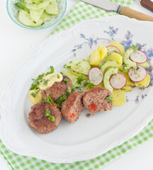 Meatball with potato cucumber and radish salad