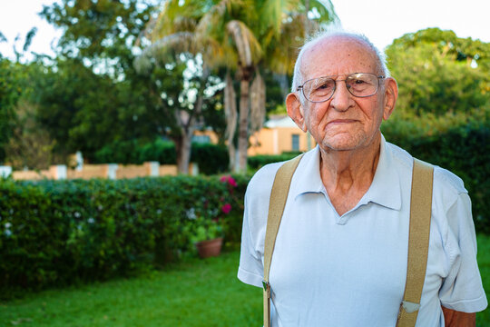 Elderly eighty year old man outdoors in a home setting