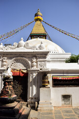 Prayer wheels in Boudhanath stupa in contrast with the blue sky. Kathmandu, Nepal.
