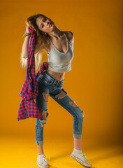 Young Woman In Yellow Tanktop And Eye Glasses Against Yellow Background