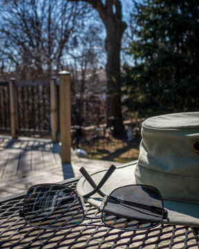 hat and sunglasses on patio table