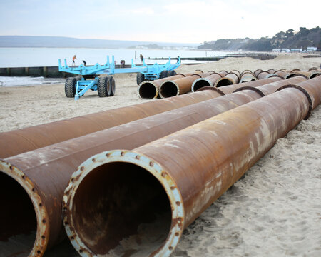 Huge metal pipes on Bournemouth beach in the UK