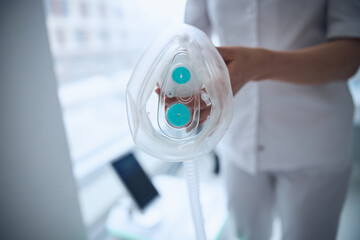 Qualified lady doctor getting ready for the oxygen therapy