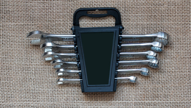 Mechanic's tool set of spanners in a package on a gray background