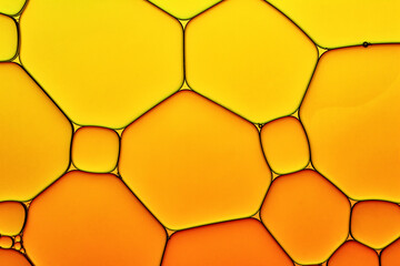 Bright Hot Background Closeup of Oil Drops in Water. Abstract Art Macro Photo of Liquid Surface with Gradient Yellow and Orange Bubbles. - obrazy, fototapety, plakaty