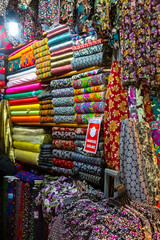 Arab store selling a variety of fabrics, Fabric in rolls
