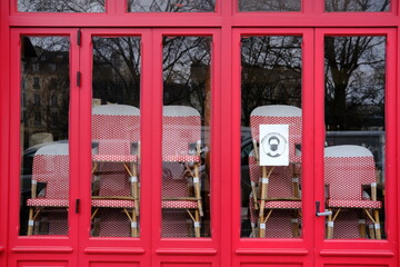 Some chairs stacked at a closed parisian cafe due to the coronavirus pandemic. Paris march 2021.