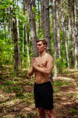 Young sporty man prepares to run sprint. Training outdoors at sunrise