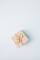 present gift box wrapped with craft paper and ribbon