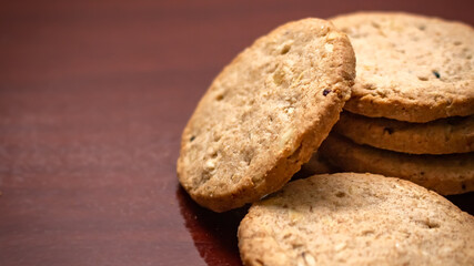 Closeup Wholegrain oatmeal cookie on wooden table with copy space.