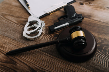 Justice and law concept.Male judge in a courtroom with the gavel, working with, computer and docking keyboard, eyeglasses, on table in morning light