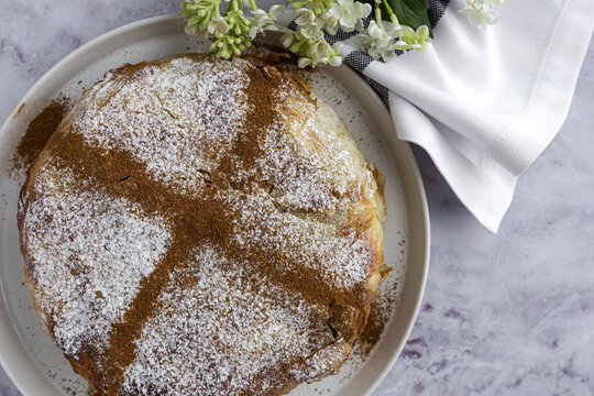 Top view of appetizing bastilla with aromatic spices on table near flower sprig during Ramadan holidays
