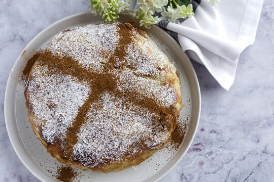 Top view of appetizing bastilla with aromatic spices on table near flower sprig during Ramadan holidays