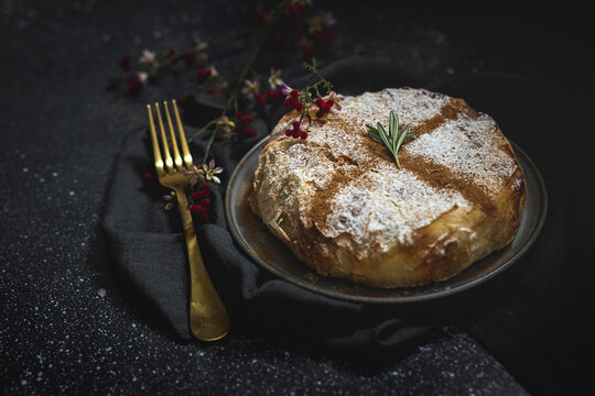 From above of appetizing bastilla with aromatic spices on table near flower sprig during Ramadan holidays