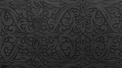 Textured black metal backdrop with ancient oriental floral wavy ornament. Background floral carved silver black, decorative asian religious chasing art.