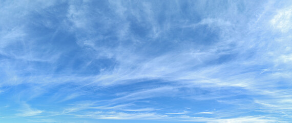 Bright blue sky with fine cirrus clouds