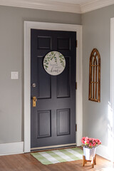 Interior view of front door with a cute sign that says Home Sweet Home