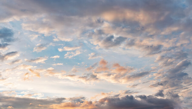 Evening sky with some yellow orange, pink, white, grey and dark clouds