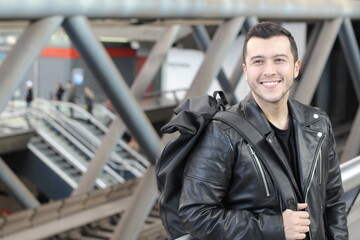 Young ethnic guy walking subway corridors