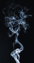 Blue curly smoke on a black background. Smoke texture