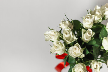 A bouquet of white tea roses on a light table background. Top view. selective focus