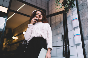 Confident young black woman speaking on cellphone outside