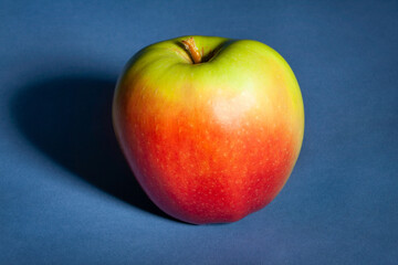 red green apple on blue background