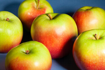 red green apple on blue background
