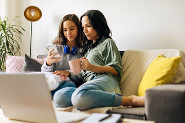 Single parenthood. Mother and daughter spending time together at home.
