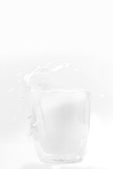 Perfect white milk glass splashing on white background