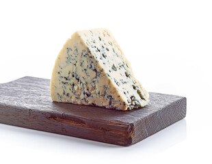 Blue cheese on wooden chopping board isolated on white background