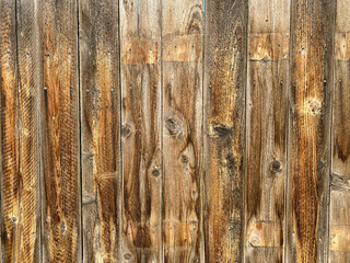old farm wooded fence board retro style with weathered and raw cut effect in sunlight