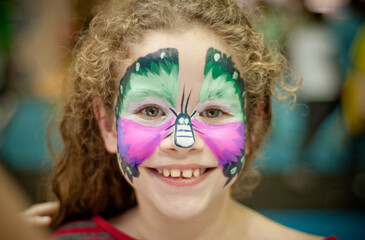 girl with butterfly drawing on her face