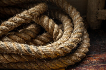 Rope on the deck of the ferry on background of the old wooden floor