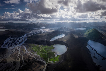 Wonderful scenery of crystal clear lake on vulcan crater surrounded by rough mountain range covered with dry vegetation on clear day