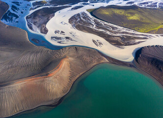 Wonderful scenery of crystal clear lake surrounded by rough mountain range covered with dry vegetation on clear day