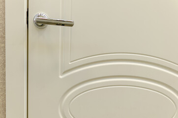 White door with a handle in the kitchen.