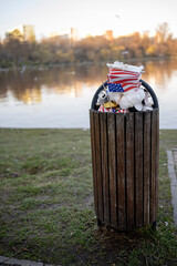 Overflowing waste from the full container placed in a public park.