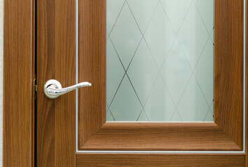 Brown wooden door with handle and glass.