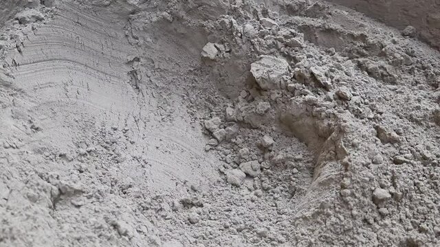 Static shot of big heap of dry cement powder at the construction site. Close up.