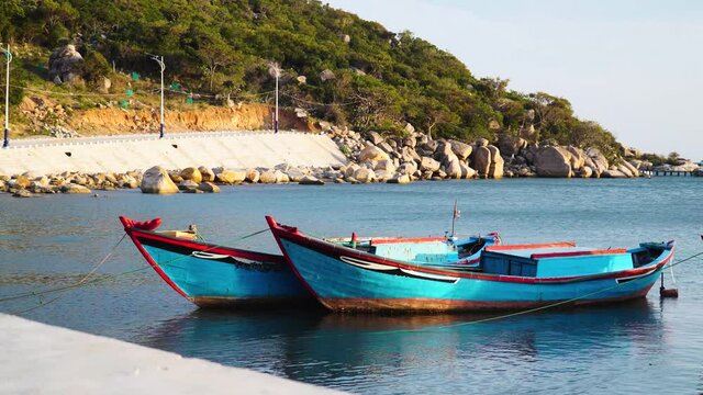 Small boats painted vivid blue in quiet haven, Vinh Hy Bay, Vietnam