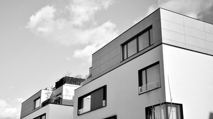 Part of city real estate property and condo architecture. Detail in modern residential flat apartment building exterior. Fragment of new luxury house. Black and white.